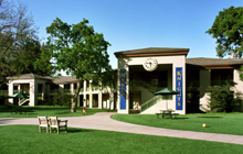 A large building with a grassy area in front of it.