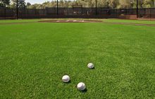 A baseball field with two balls on it.